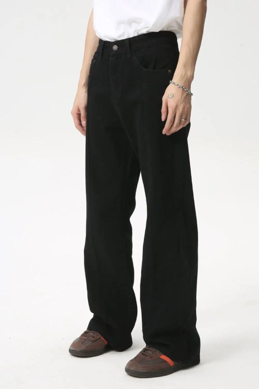 Black denim jeans with panel seams and a flare leg cut.