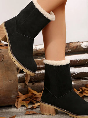 Black suede ankle boots with sherpa trim and block heel.