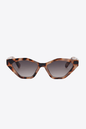 Geometric cat-eye sunglasses in leopard print with gradient lenses.