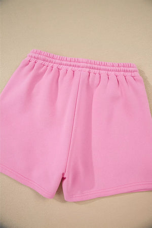 Pink cotton shorts with elastic waistband and cuffed hem