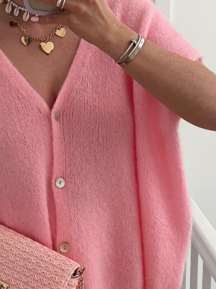 Pink mohair blend cardigan with cap sleeves and button front.