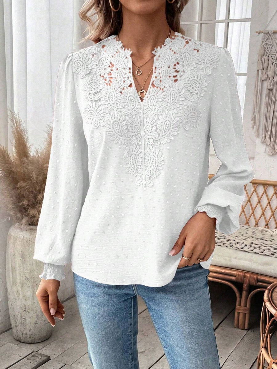 White embroidered yoke blouse with puff sleeves and textured fabric