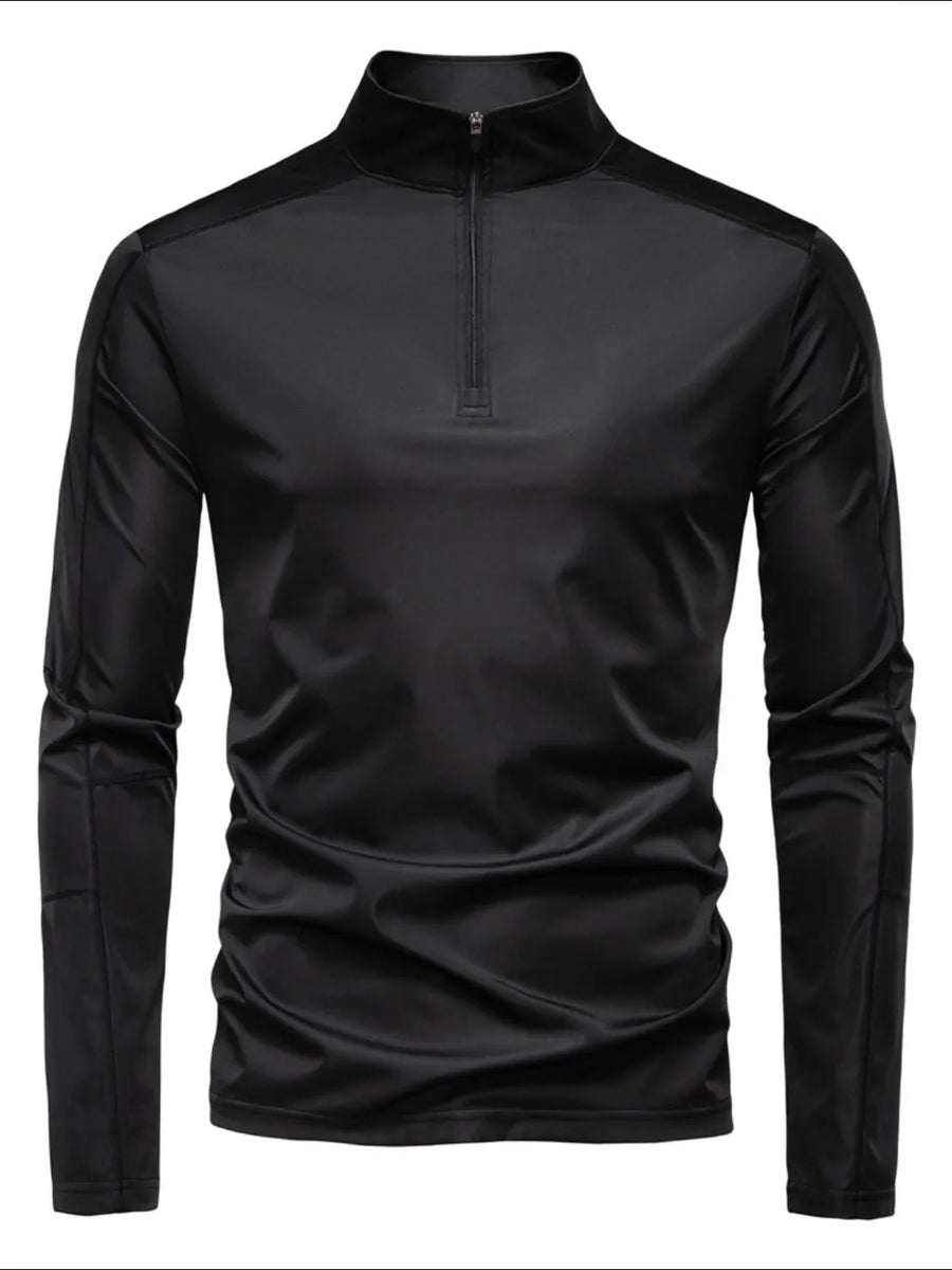 Black performance zip-neck tee with structured shoulders and long sleeves.