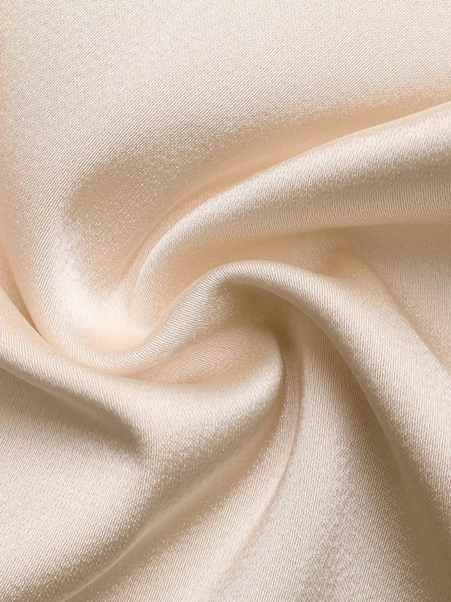 Champagne satin fabric with a subtle sheen and diagonal weave detail.