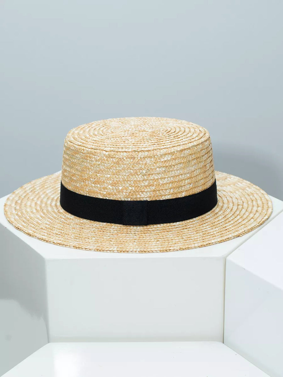Women's straw boater hat with black ribbon band