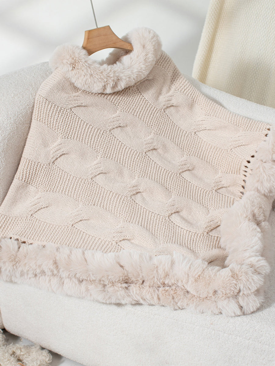 Eggshell cable knit poncho with faux fur trim and cowl neck.