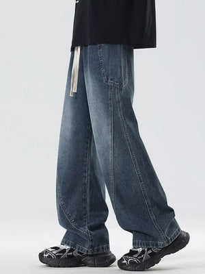 Oversized wide-leg jeans in blue denim with a drawstring waist and vintage wash.