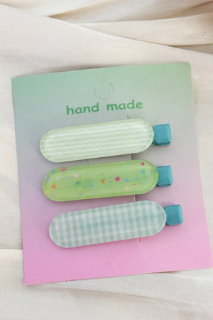 Pastel acrylic hair clips trio with gingham and star patterns in green and blue.