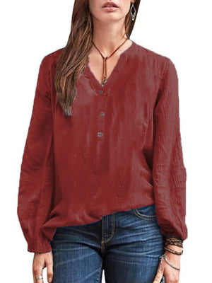 Burgundy long-sleeve blouse with notched neckline and button detail