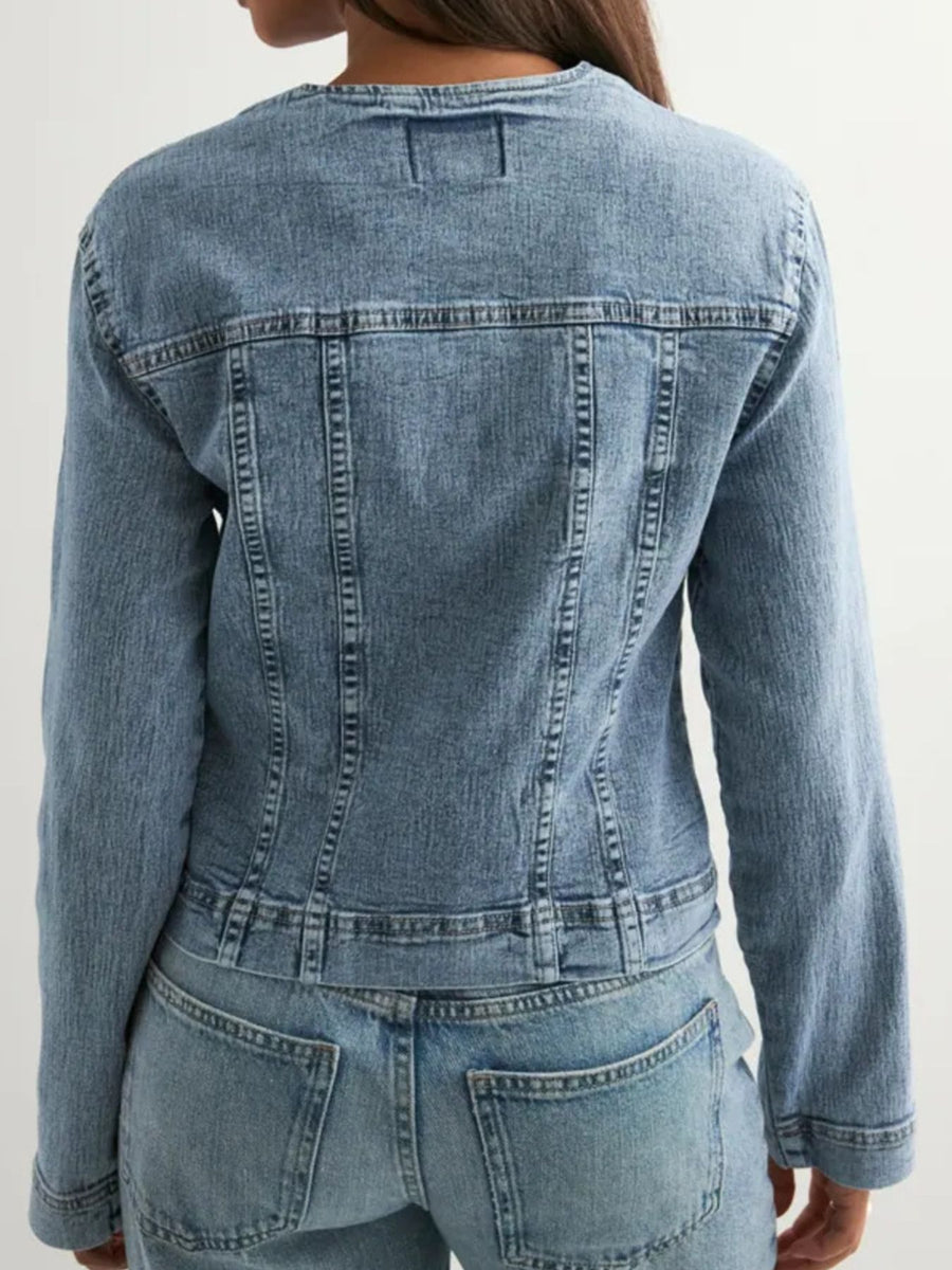 Denim jacket with seam detailing and button-down front.