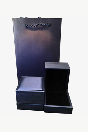 Dark blue gift bag and open ring box with velvet lining
