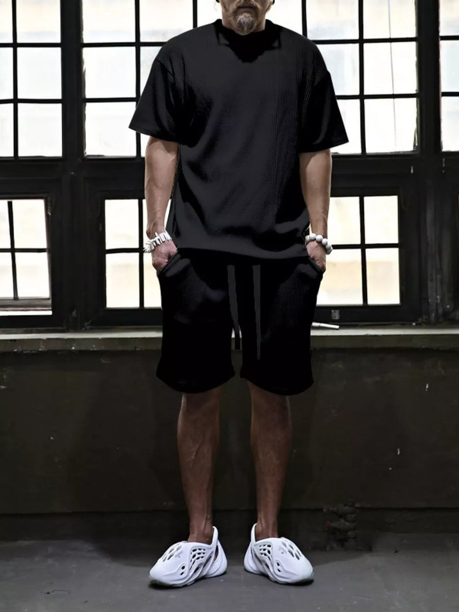 Black ribbed t-shirt and drawstring shorts set for men, casual comfort style.