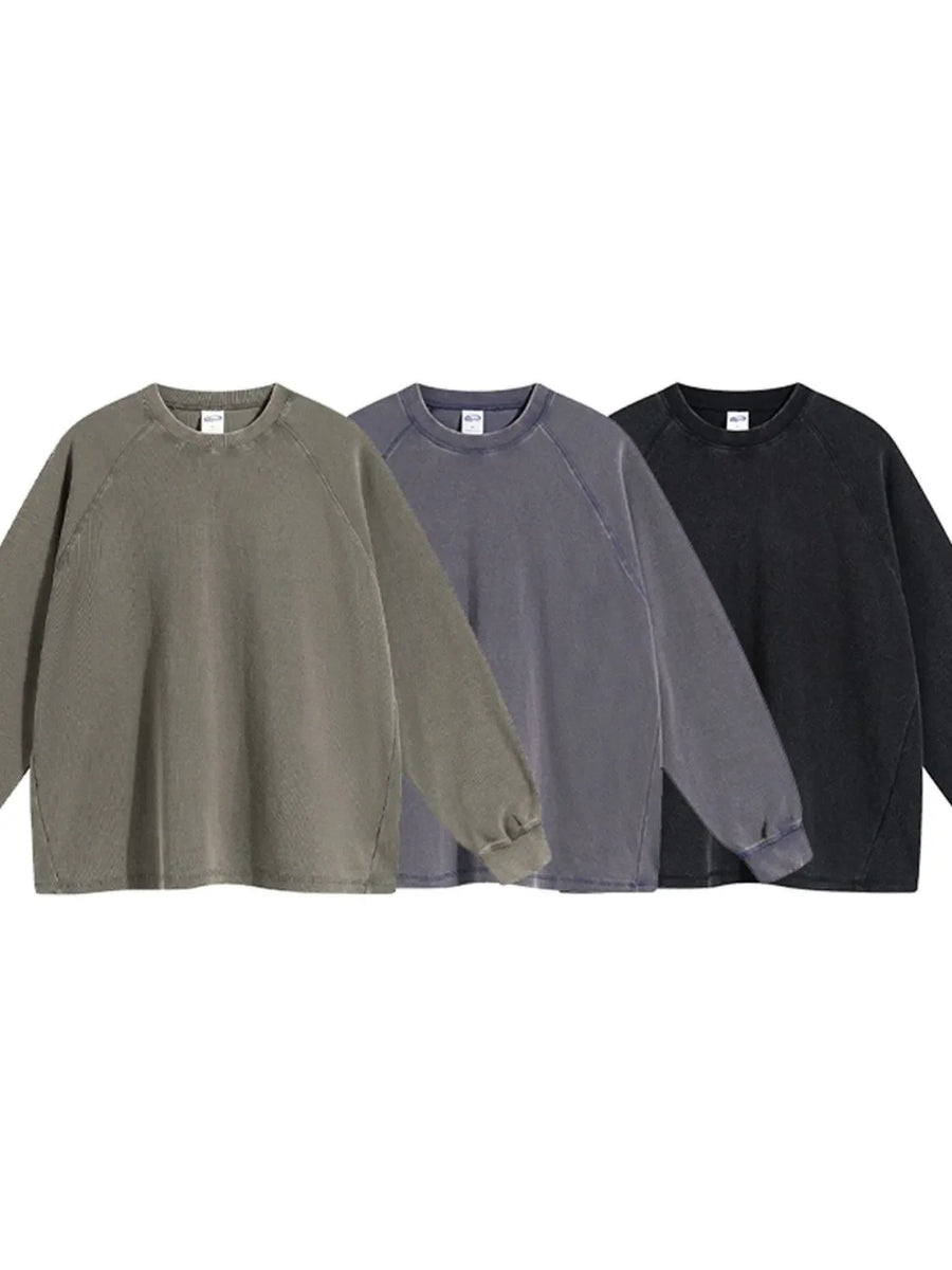 Raglan sleeve washed cotton sweatshirt in olive, dark gray, and black with crew neck.