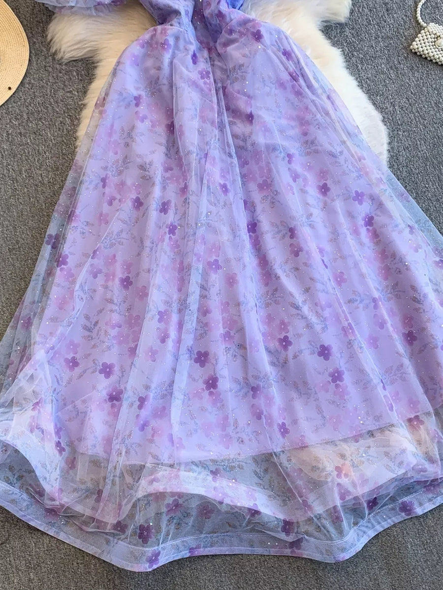Purple floral maxi dress with sheer overlay and glitter detail.