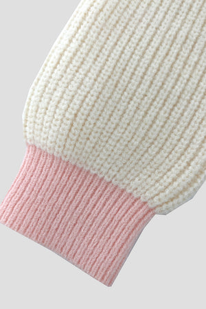 Cream acrylic knit cardigan with pink contrast trim on the cuff.