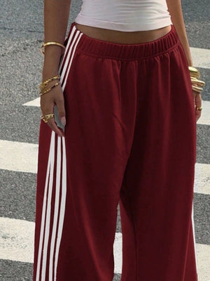 Navy track pants featuring high-waisted and striped