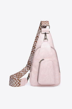 Blush pink PU sling bag with geometric strap and front zip pocket.