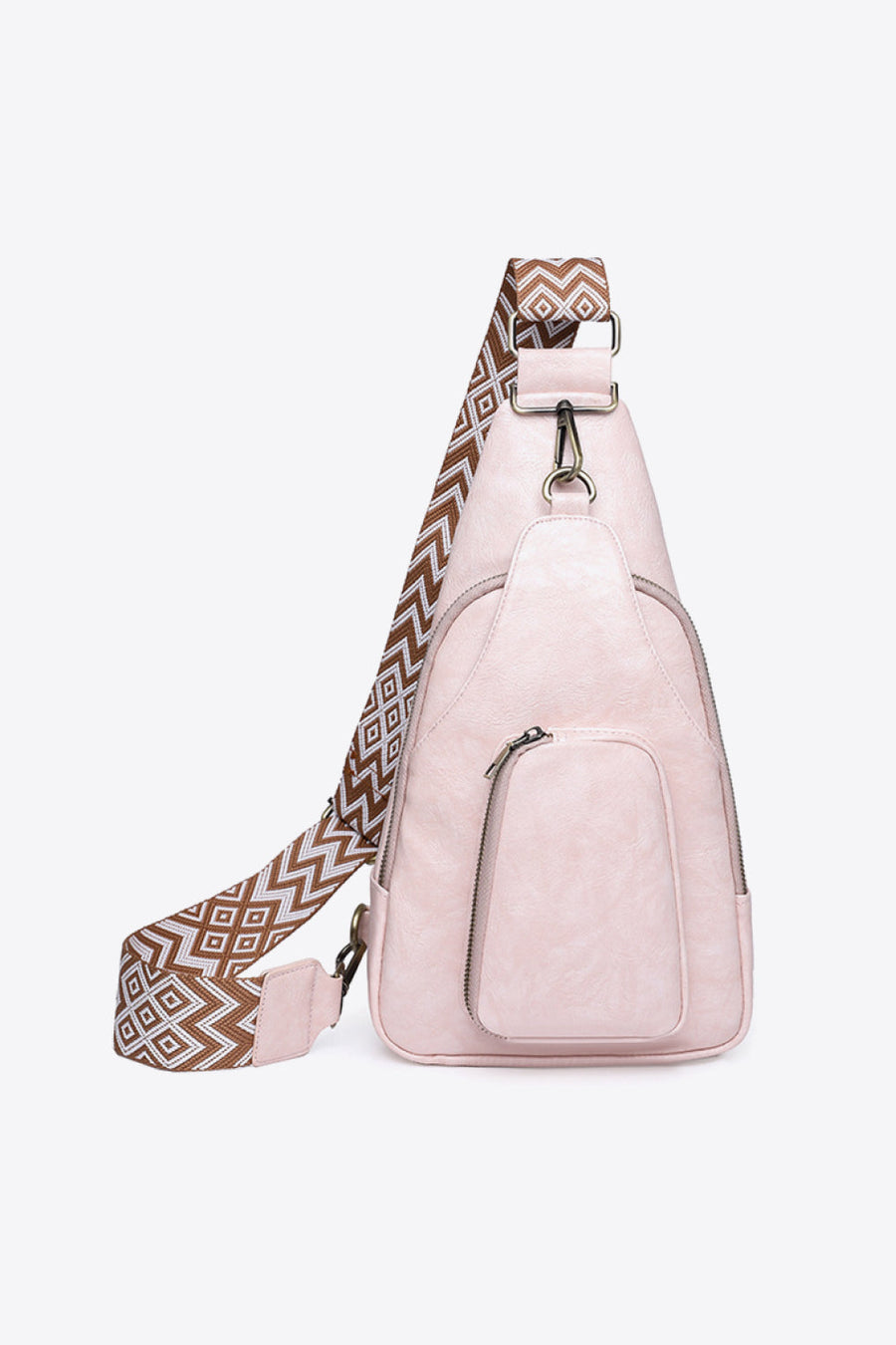 Blush pink PU sling bag with geometric strap and front zip pocket.