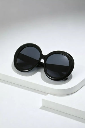 Chic oversized round black fashion sunglasses with dark lenses.
