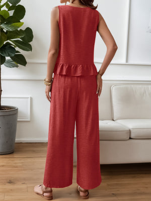 Red ruffled hem sleeveless top and wide-leg pants set with textured fabric.