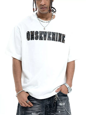 Oversized white cotton t-shirt with black textured logo graphic on chest.