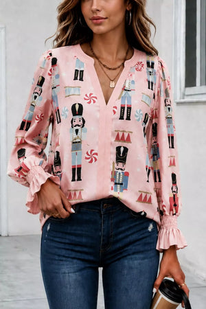 pink blouse with nutcracker print and v-neck
