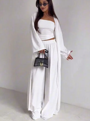 White three-piece maternity set with crop top, wide-leg pants, and open cardigan.