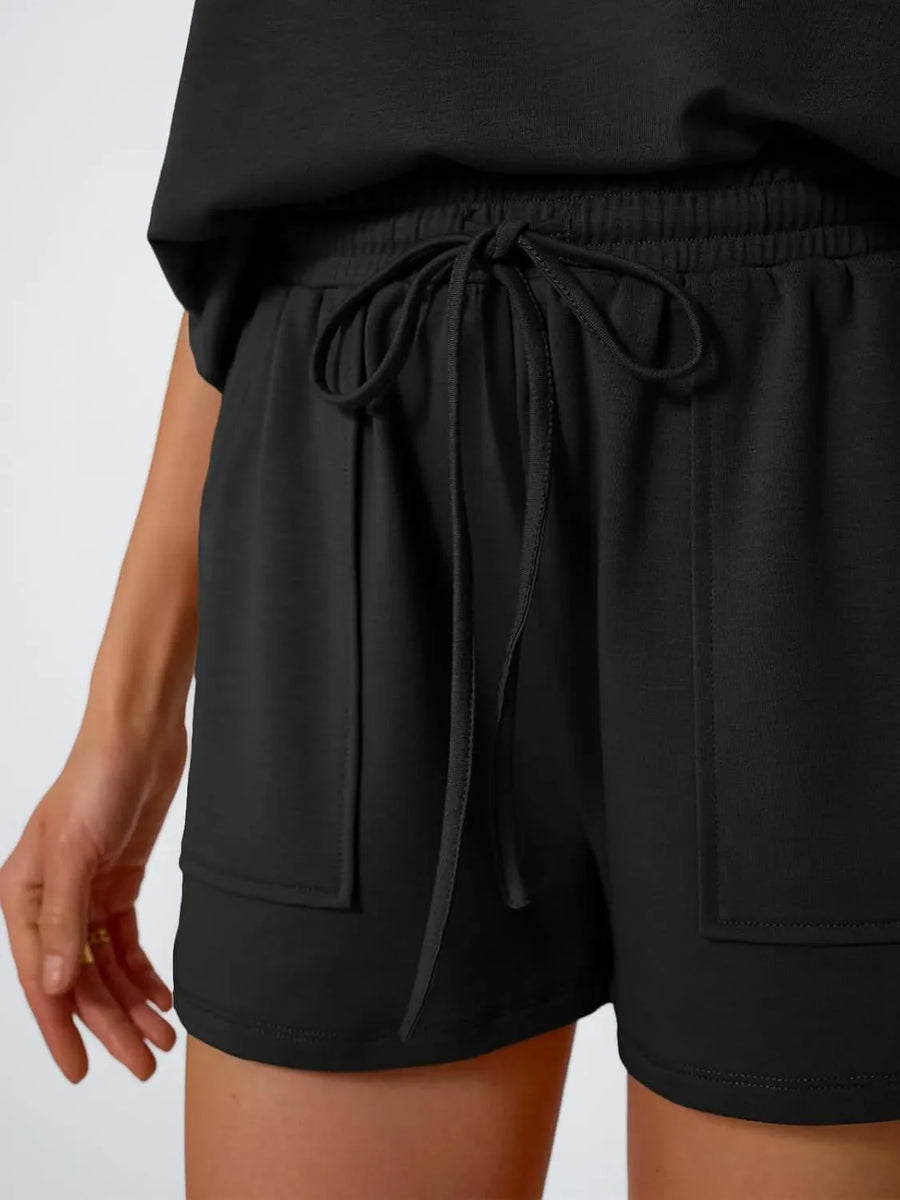 Black drawstring shorts with elastic waist and patch pockets