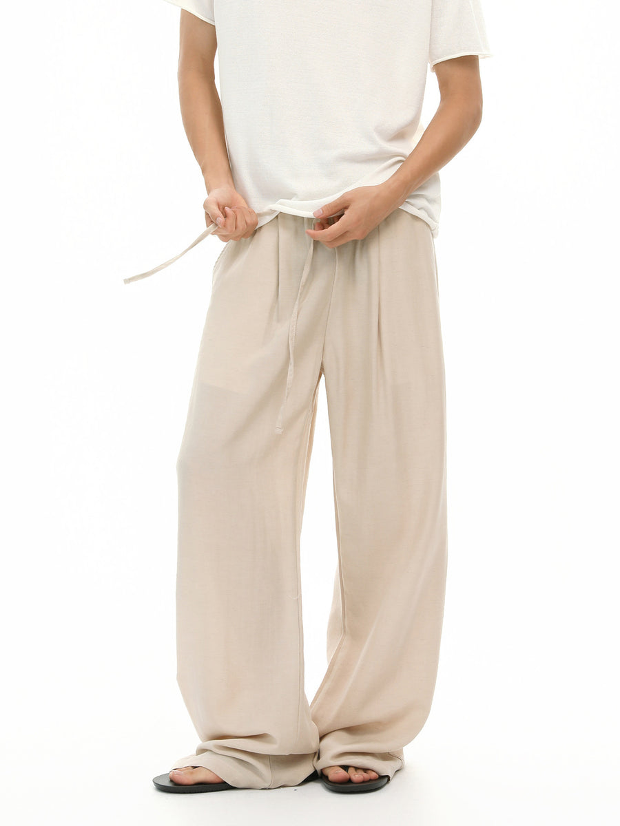 wide-leg pants in light beige featuring drawstring waist and loose fit