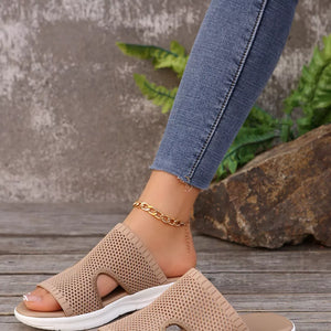 Khaki mesh slide sandals with open toe and white sole, styled with a gold chain anklet.