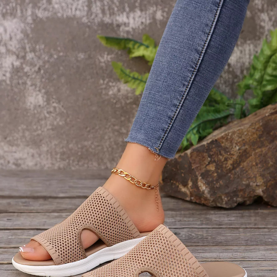 Khaki mesh slide sandals with open toe and white sole, styled with a gold chain anklet.