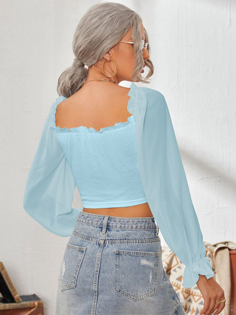 Pastel Blue smocked bustier crop blouse with square neckline and ruffled cuffs.
