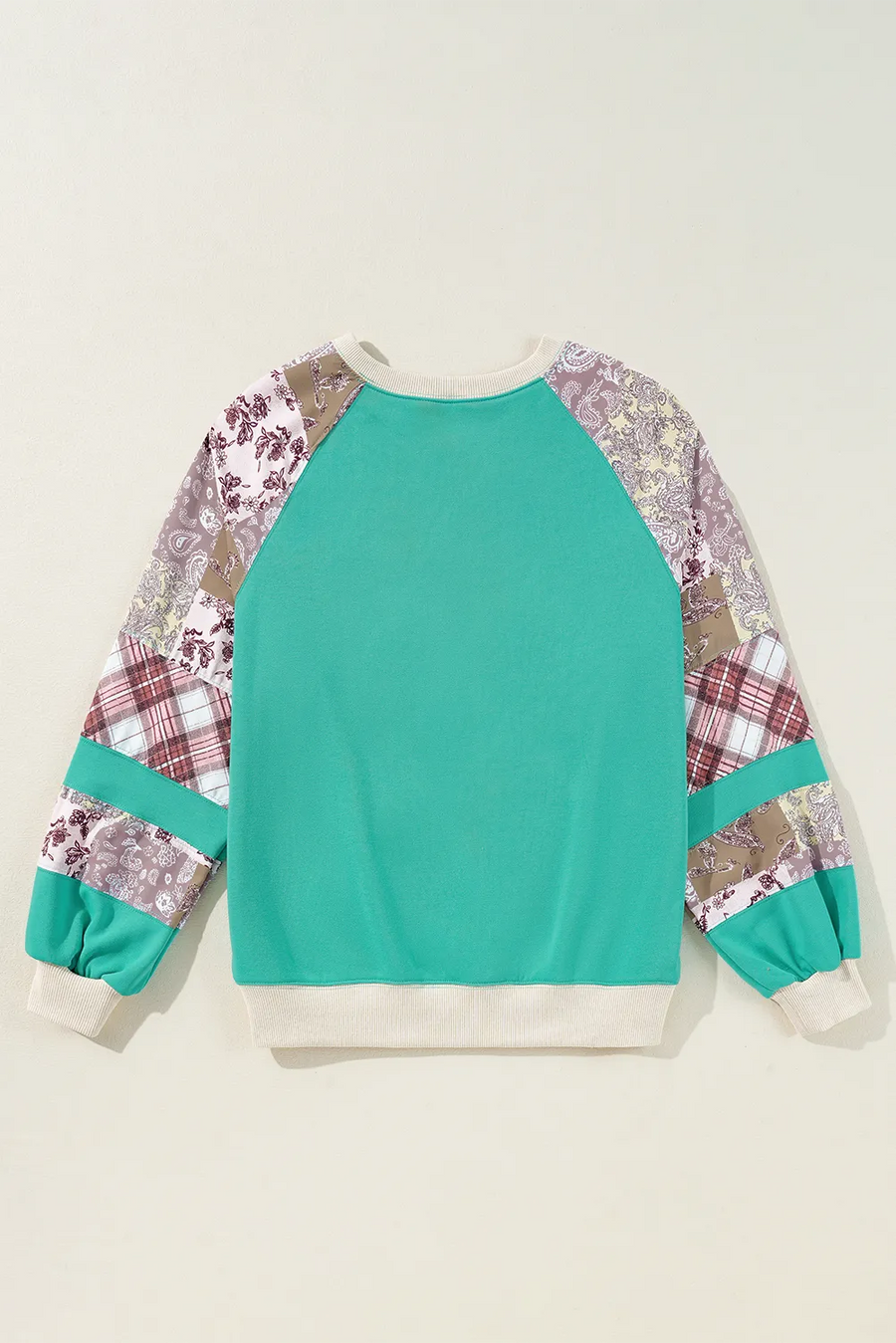 Turquoise patchwork raglan sleeve sweatshirt with paisley and plaid details.
