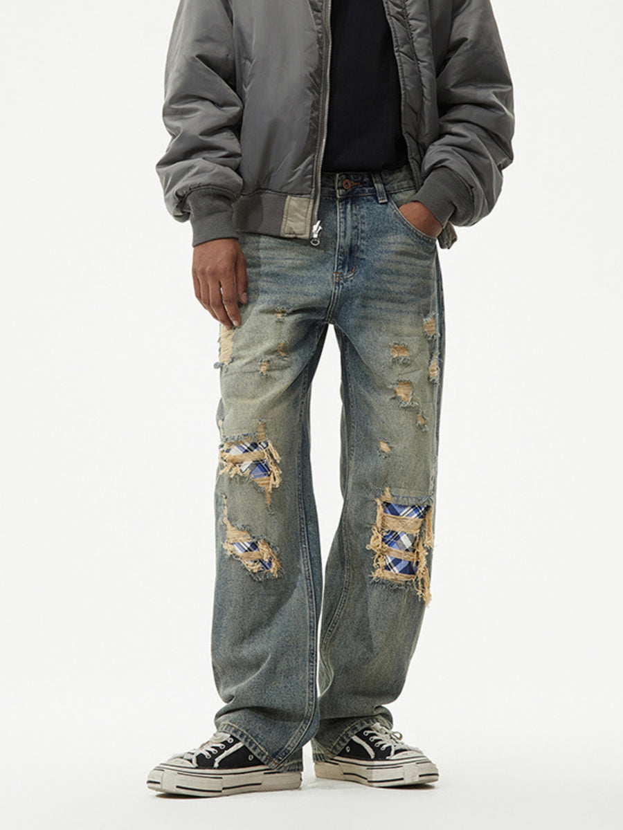 Distressed blue plaid patch wide leg jeans with ripped details.