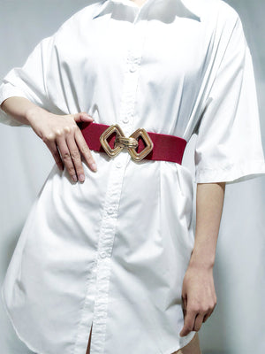 Red elasticated waist belt with gold geometric buckle detail