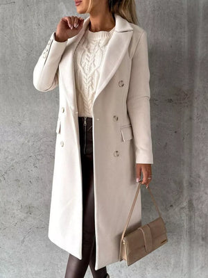 Chic double-breasted longline trench coat in apricot with button details.