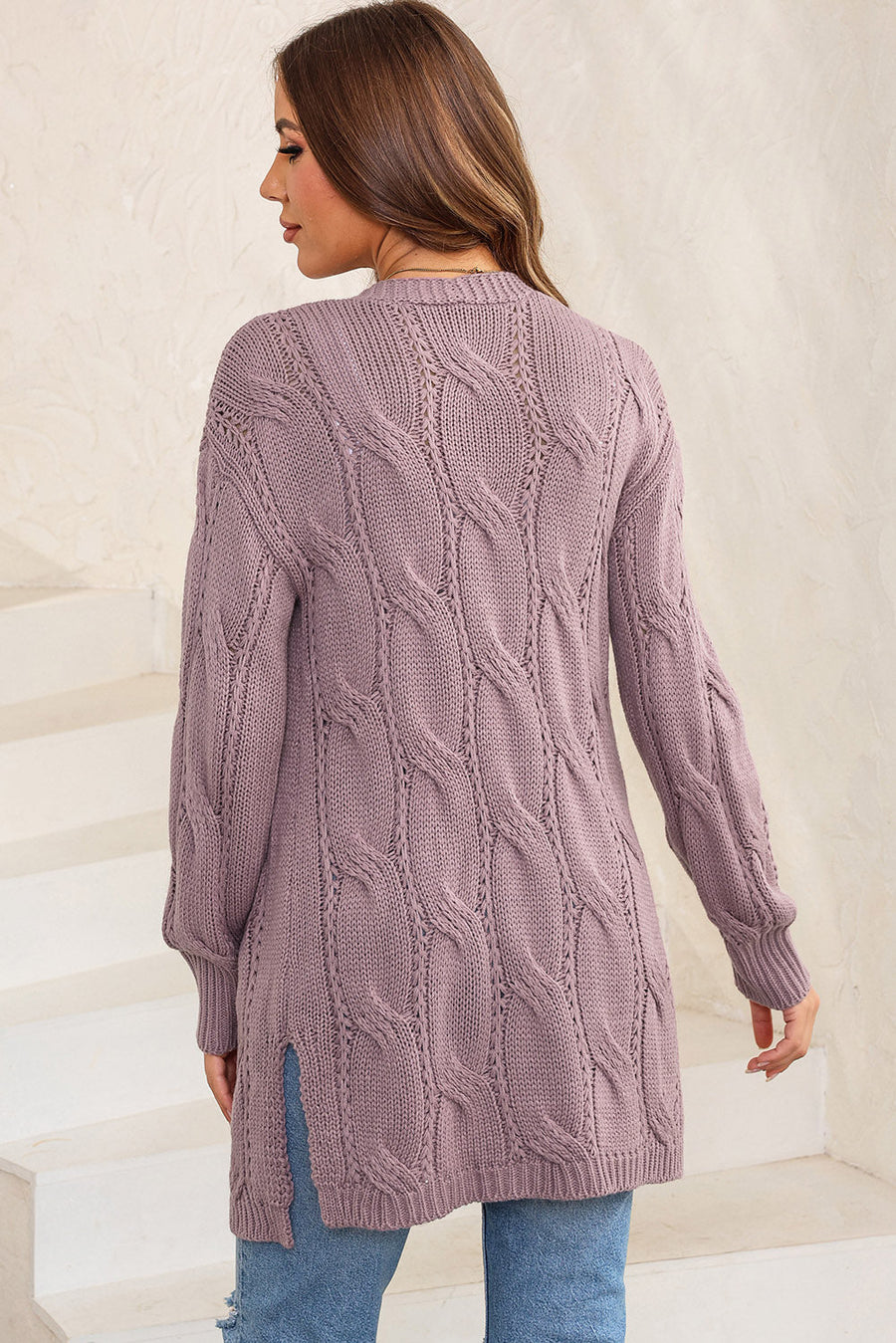 Lilac cable knit long cardigan with open front and side slits.