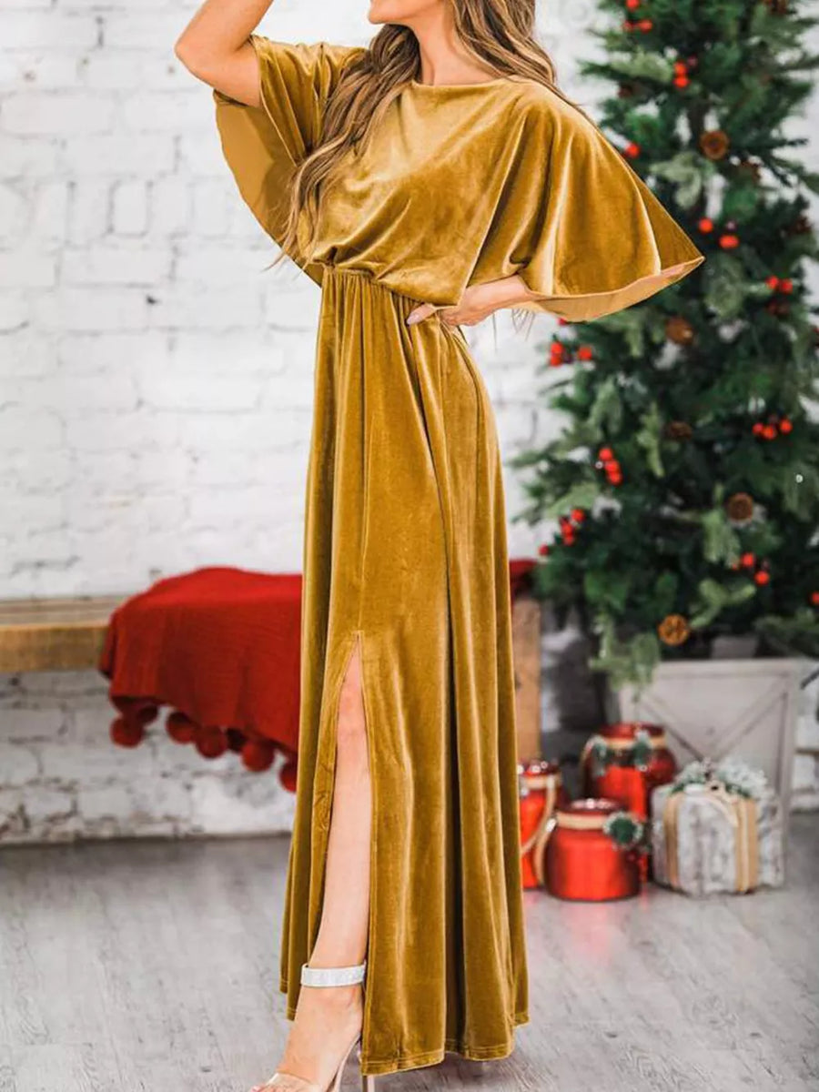 Gold velvet maxi dress with flutter sleeves, cinched waist, and high slit.