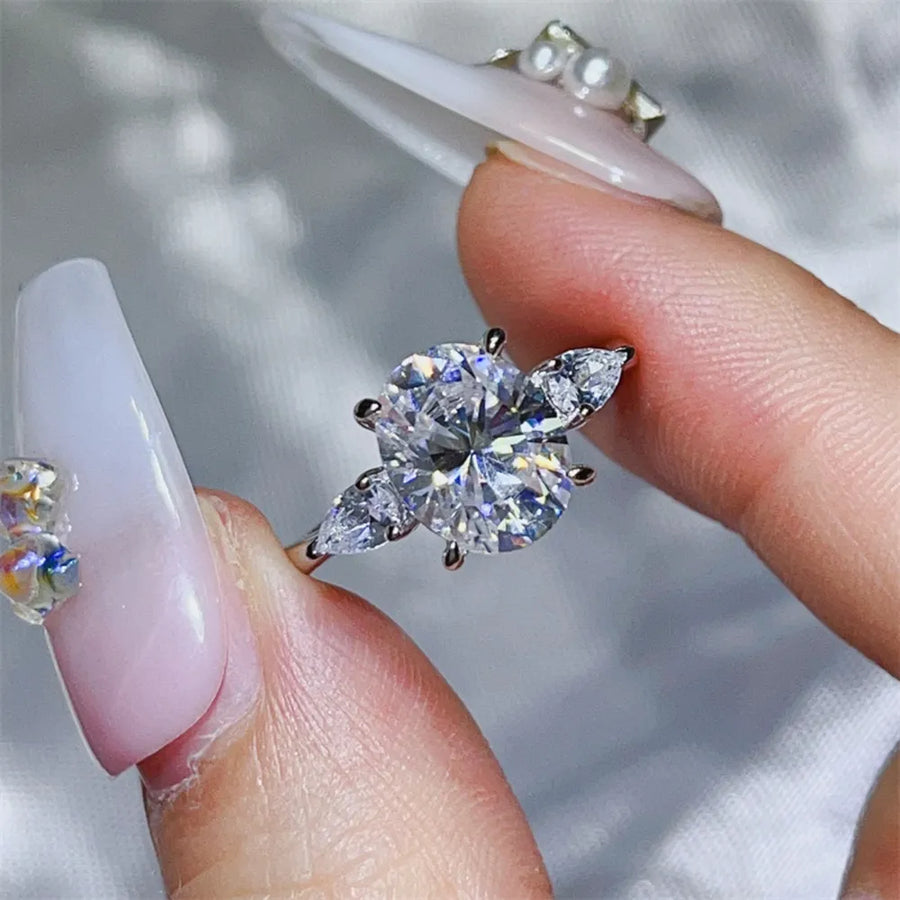 Platinum-plated, 925 sterling silver, Moissanite, Zircon (accent stones) Carat w ring in clear with three-stone oval with