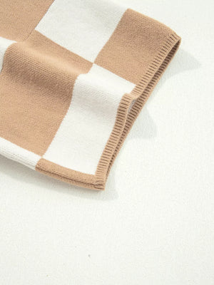 Drop shoulder sweater in camel and white checkerboard pattern with ribbed trim.