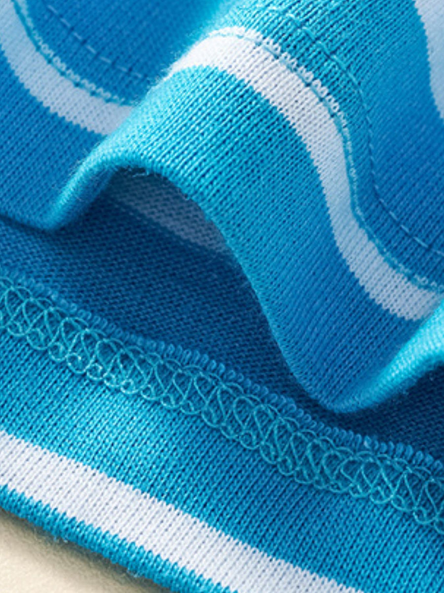 Blue and white striped cotton toddler dress detail with decorative stitching.