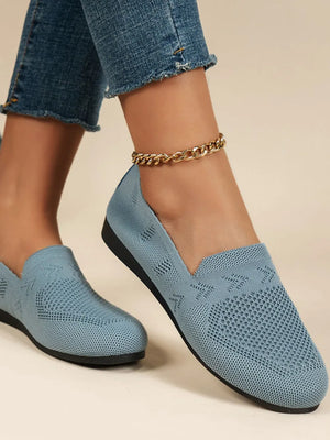 Light blue breathable knit slip-on loafers with a textured pattern and a gold anklet.