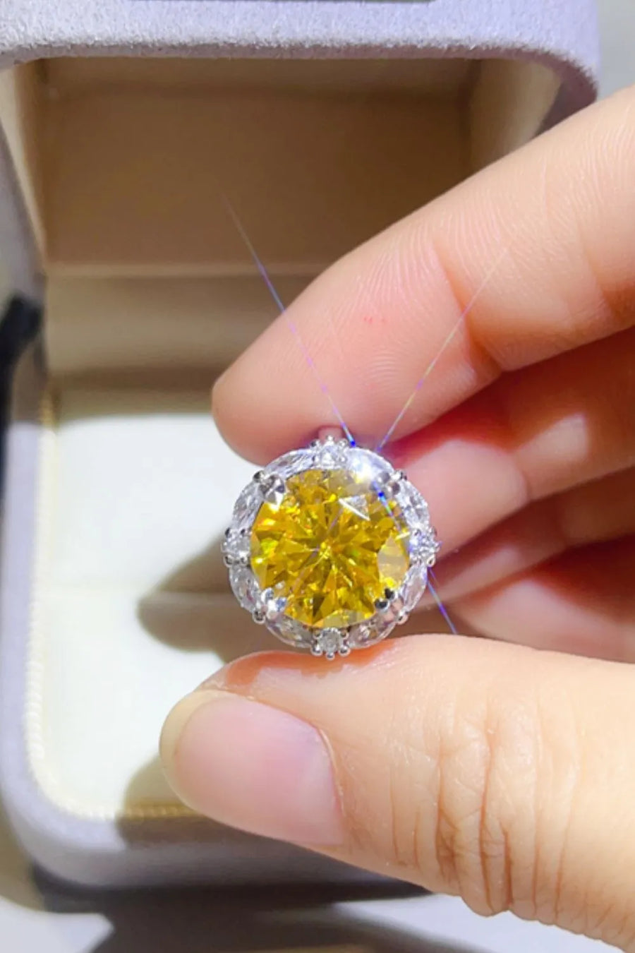 Radiant Halo Yellow Gemstone Ring with clear accent stones.