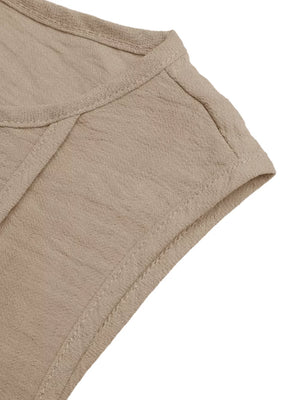 Textured beige maxi dress detail showing seam and fabric texture.