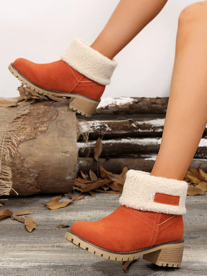 Orange suede ankle boots with sherpa trim and block heel.