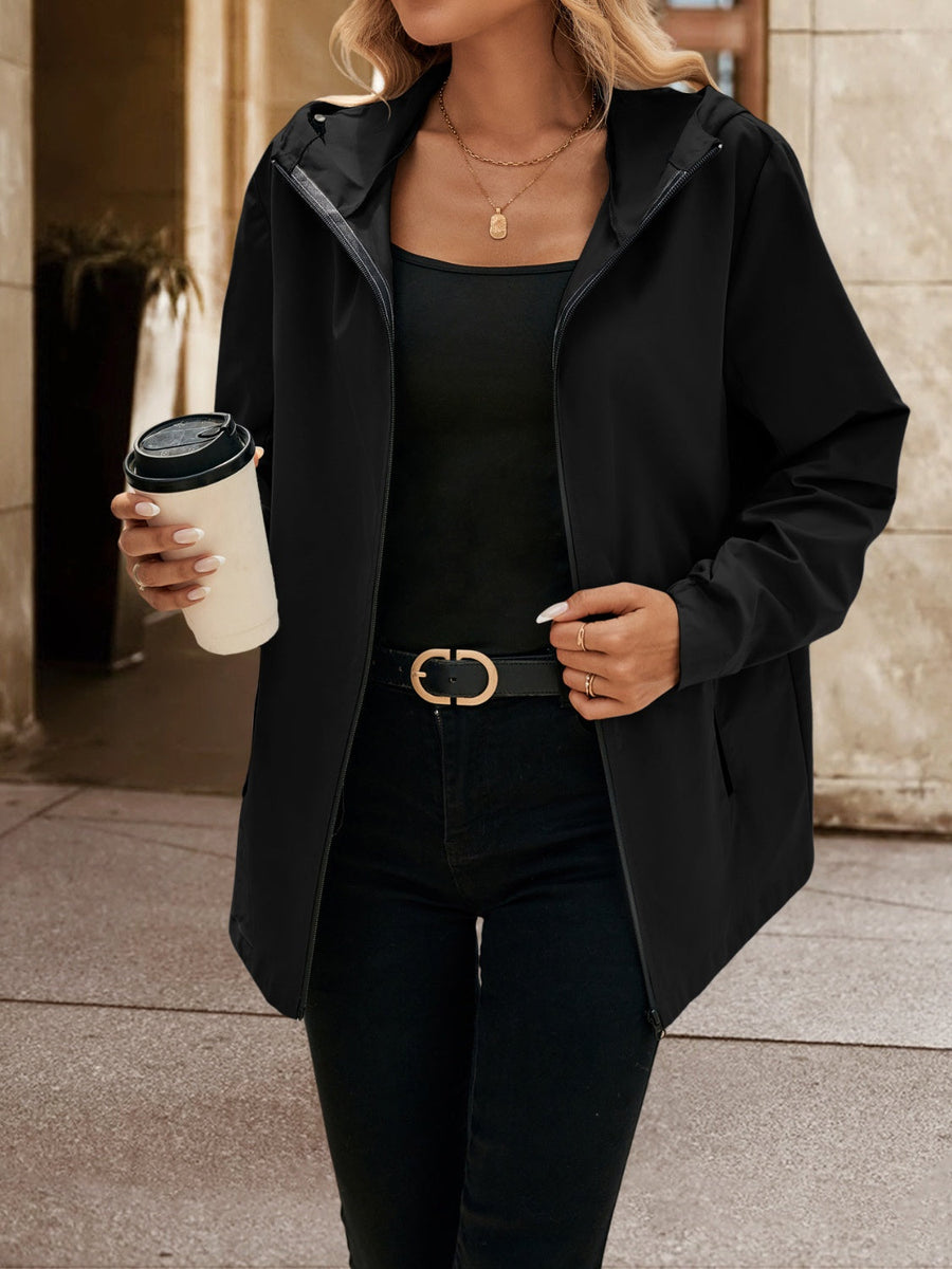 Black zip-through hooded jacket with a casual cut, worn open over a black tank top.