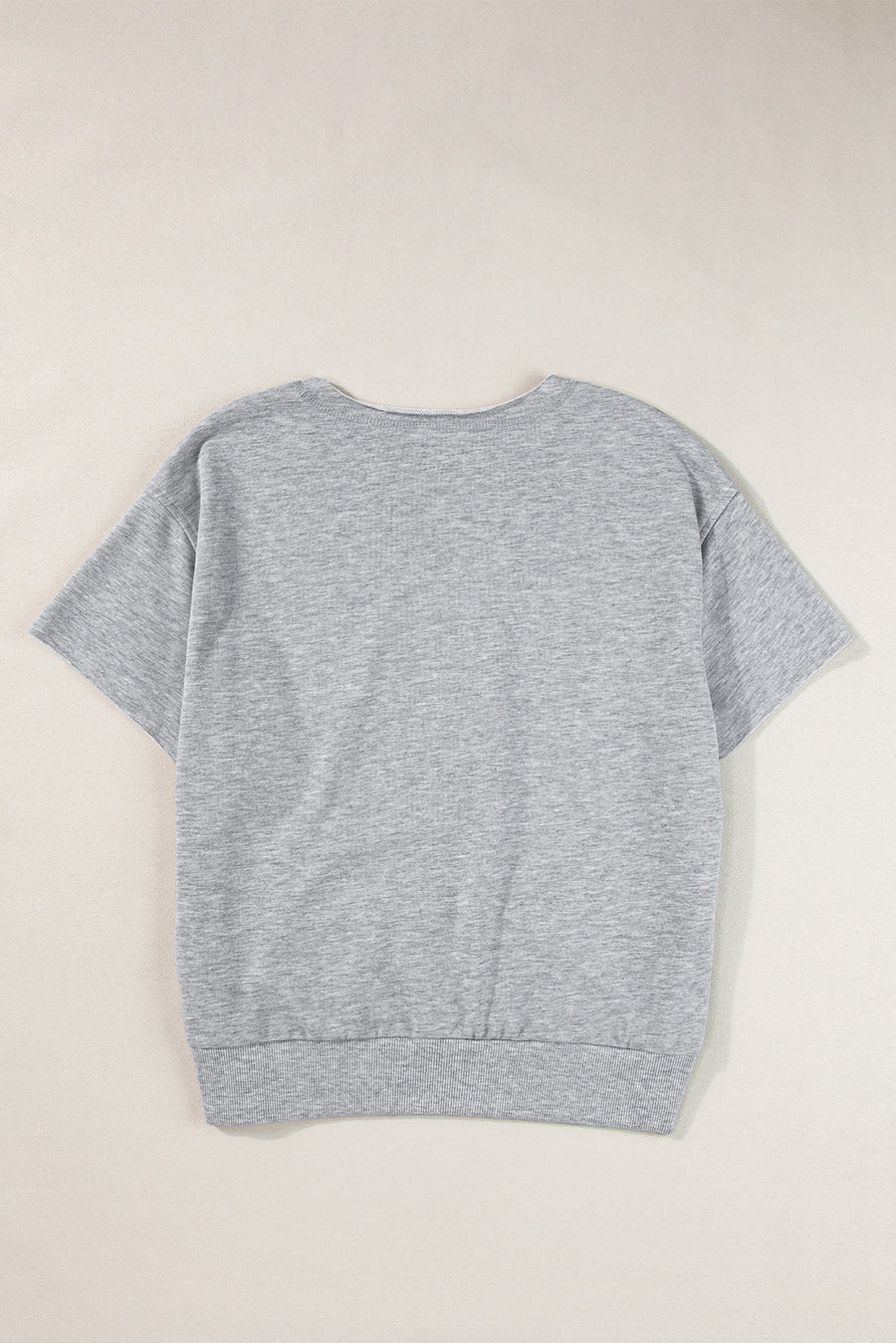 Gray short sleeve sweatshirt with a notch neckline and ribbed hem.