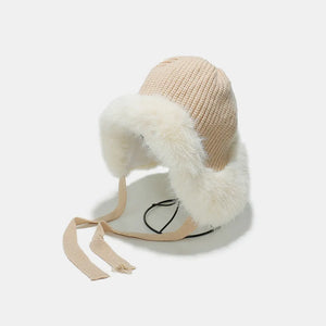 Ivory trapper hat with faux fur trim and ear flaps.