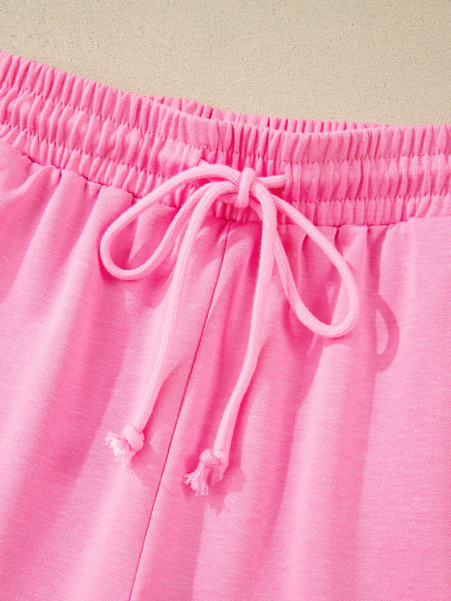 Pink cotton bikini bottoms with elastic waistband and drawstring detail.