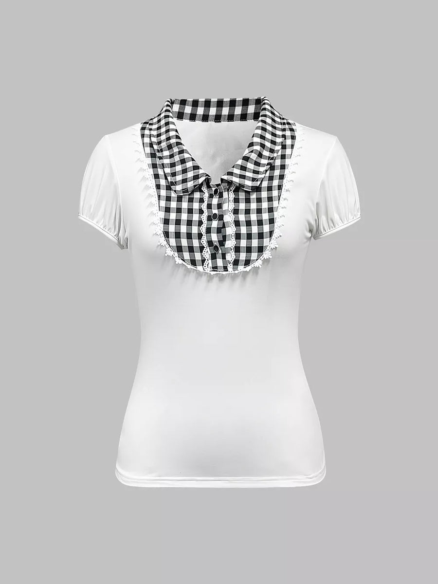 White maternity shirt with black gingham collar, lace trim, and decorative buttons.